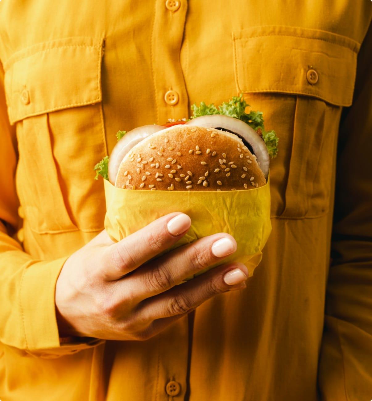 Hand holding burger